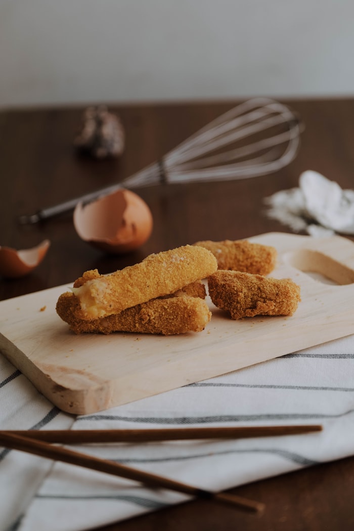 Golden crispy fried mozzarella cheese bites with hot spicy marinara dip
