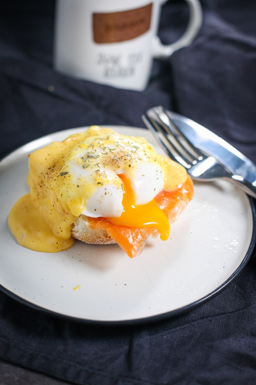 Toasted English muffin half crowned with Canadian bacon, poached egg, and golden hollandaise