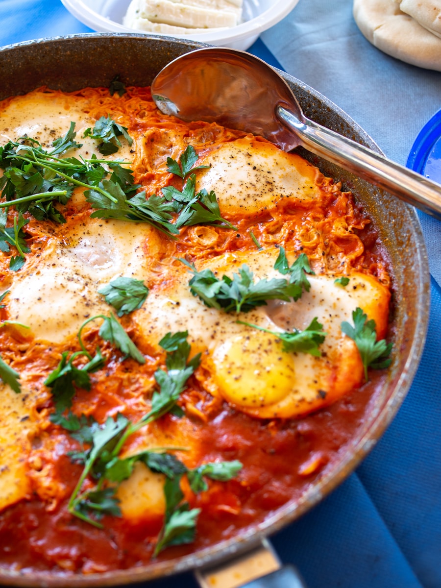 Eggs poached in fiery skillet marinara sauce with parmesan and basil