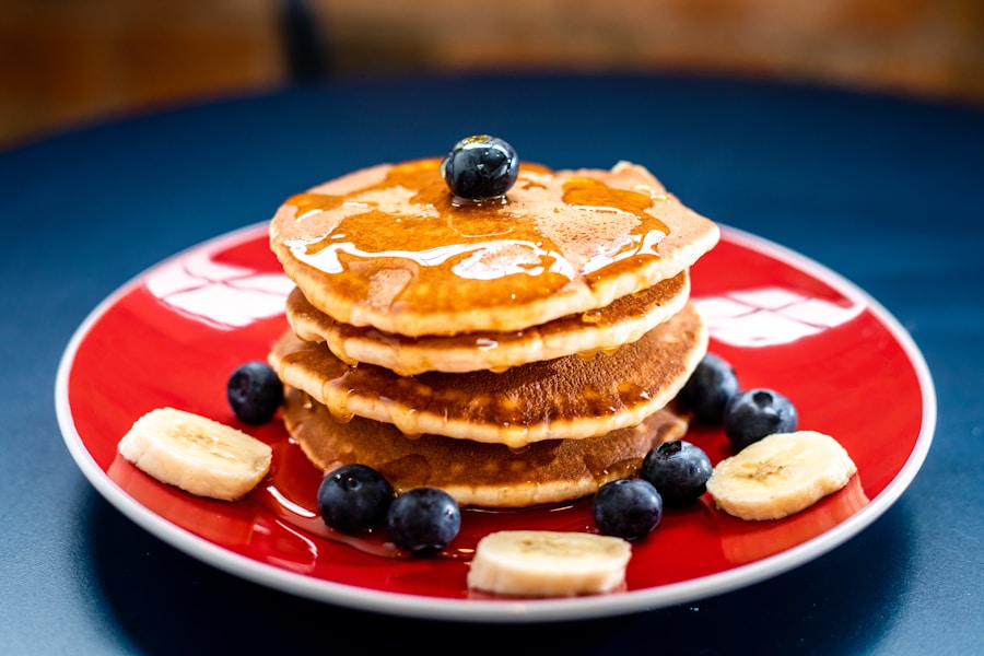Plate of torn Austrian Kaiserschmarrn pancakes dusted with powdered sugar and berries