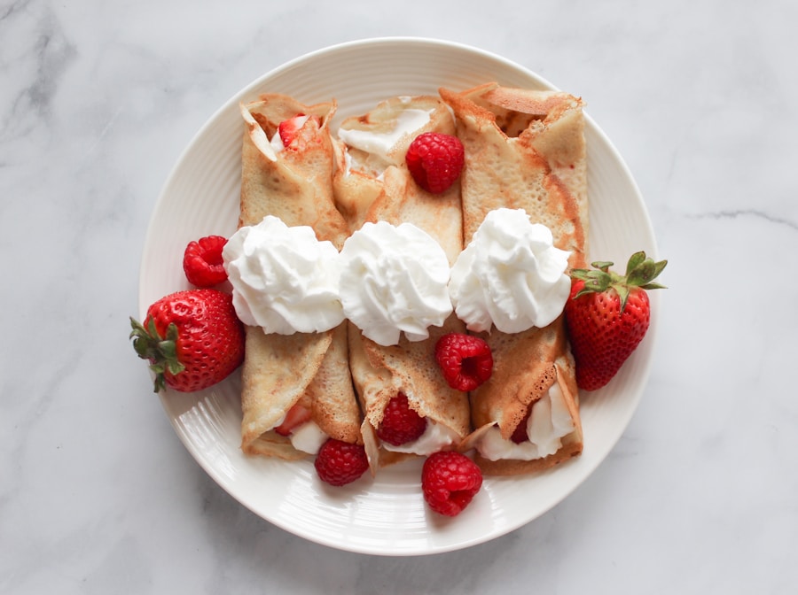 Glazed triangular strawberry scones topped with pink strawberry drizzle on parchment