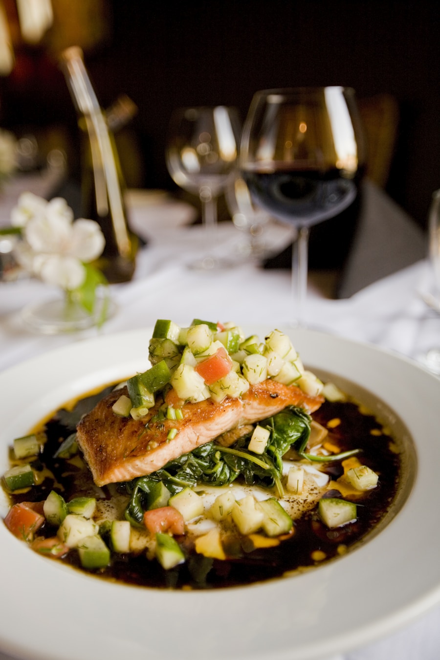 Plate of white bean and wild salmon salad with fresh greens and lemon