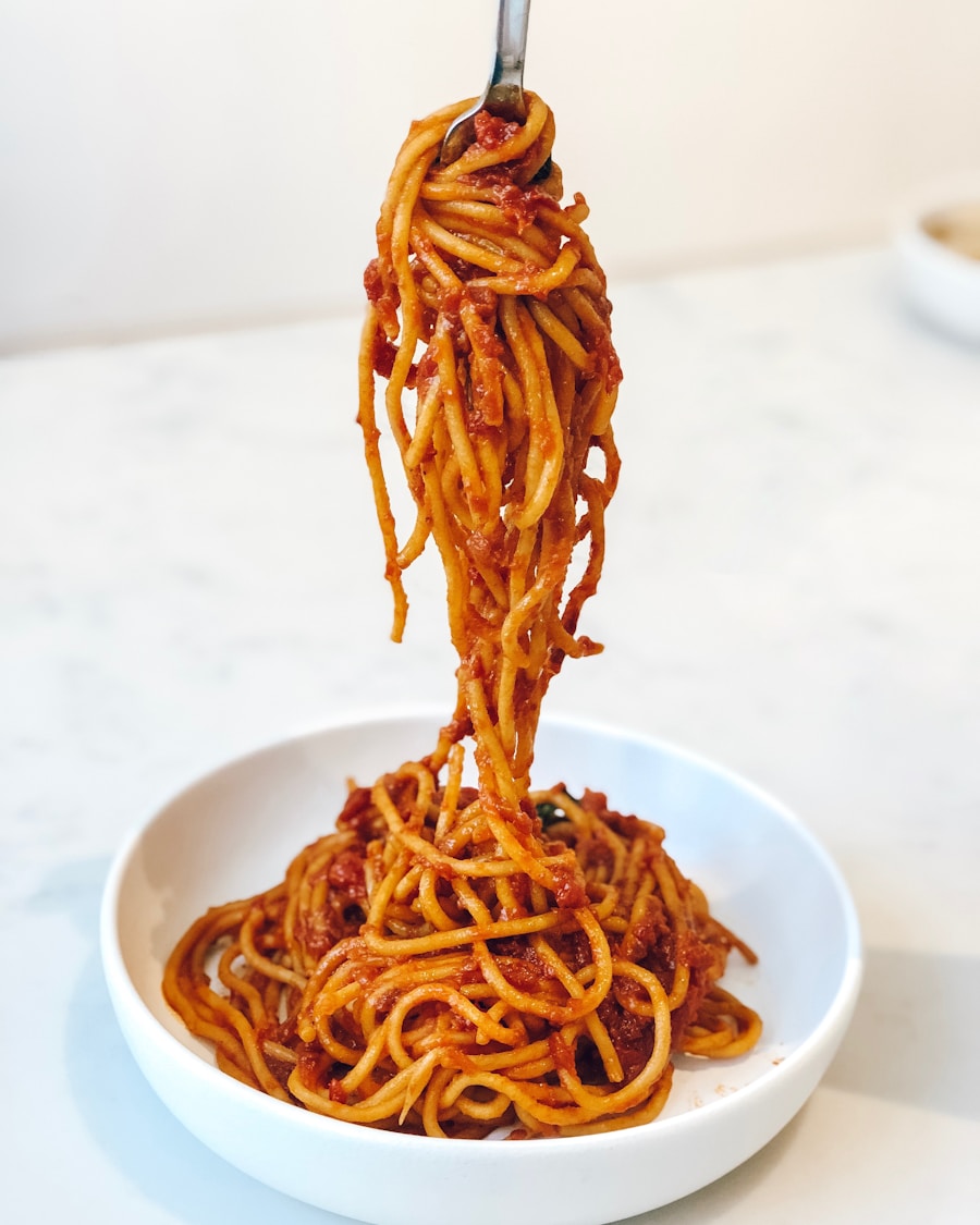 Twirl of creamy lemon mascarpone spaghetti topped with fresh basil and black pepper