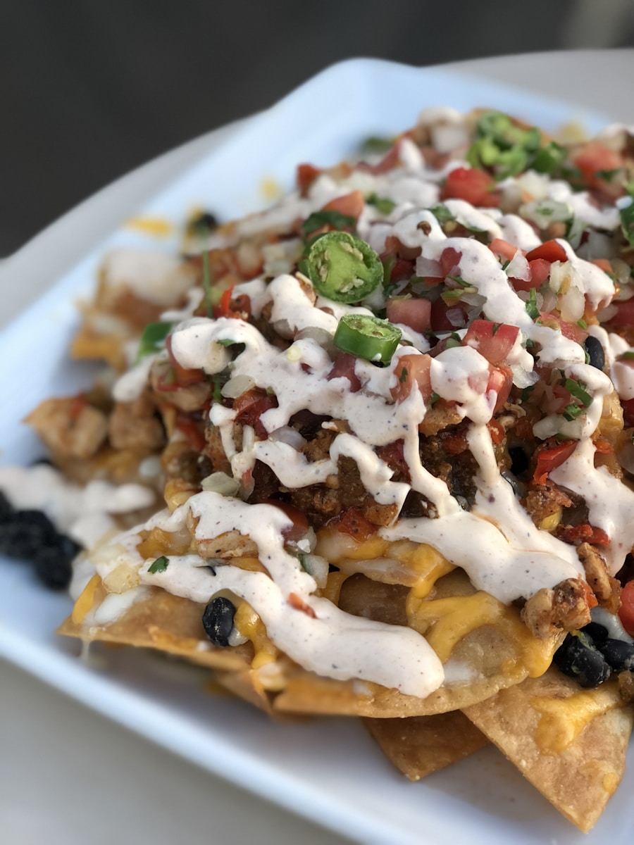 Plate of warm melted cheese nachos piled high with sweet lump crab meat and Old Bay seasoning